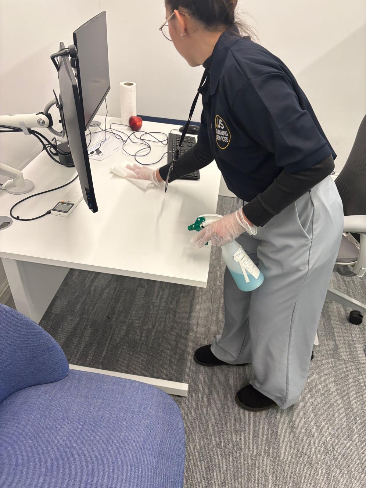 Professional cleaning team Dublin cleaning an office desk
